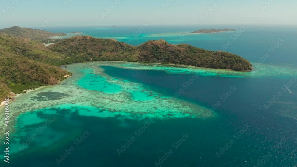 aerial view tropical island Bulalacao with blue lagoon, coral reef and sandy beach. Palawan, Philippines. Islands of the Malayan archipelago with turquoise lagoons. aerial view tropical island Bulalacao with blue lagoon, coral reef and sandy beach. Palawan, Philippines. Islands of the Malayan archipelago with turquoise lagoons.