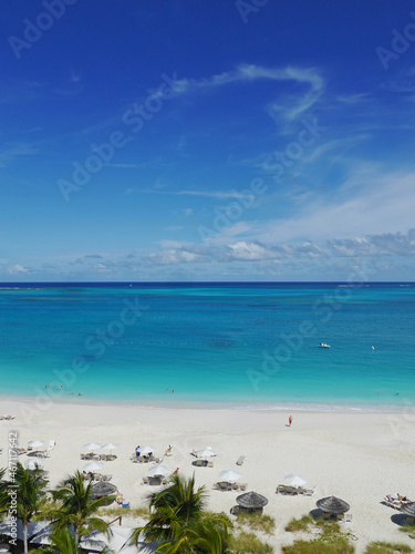 Fototapeta Naklejka Na Ścianę i Meble -  Caribbean Beach, Turquoise Sea, Palm Trees and Umbrellas (Grace Bay, Turks and Caicos Islands)	