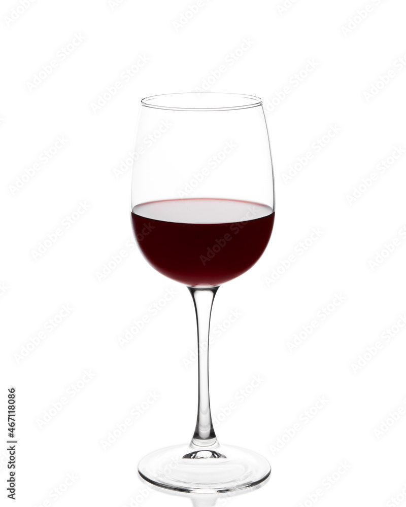 Red wine in a glass. Glass with red wine on a white background. The glass is covered with condensation from cold wine.