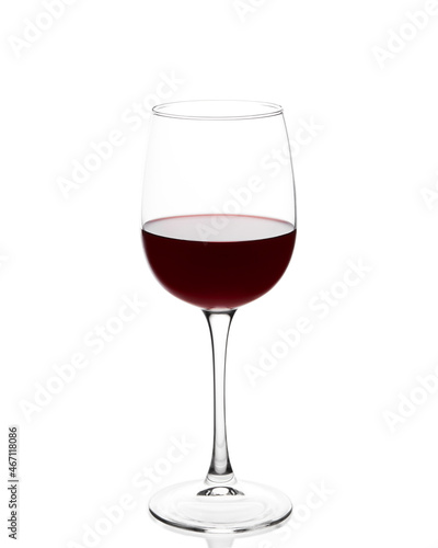 Red wine in a glass. Glass with red wine on a white background. The glass is covered with condensation from cold wine.