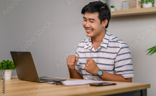 male employee working in office with laptop