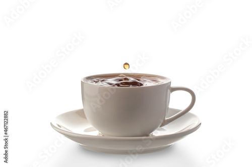 white porcelain cup with spilled tea, isolated on a white background