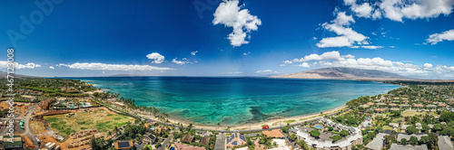 Panoramic perspective view into Teal water from beautiful Hawaiian Island of Maui with white sand beach in Kihei