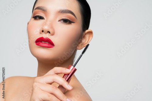 Portrait of Beautiful Asian woman with mascara in hand