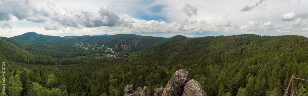 Panoramic view from sandstone rock viewpoint Monchskanzeland on spruce tree forest, village Oybin and Zittauer Gebirge mountains nature park, summer landscape, Germany