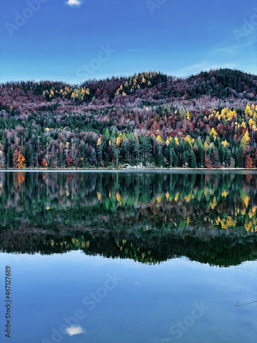 beautiful autumn mood in the mountains with colorful forest and reflection in lake
