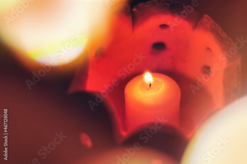 Romantic background in soft focus. A small candle burns in a pumpkin-carved candlestick. © Николай Батаев