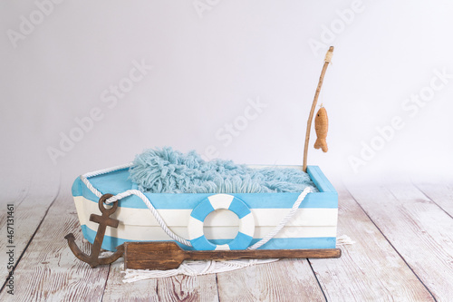white and blue wooden boat with fish on the rod