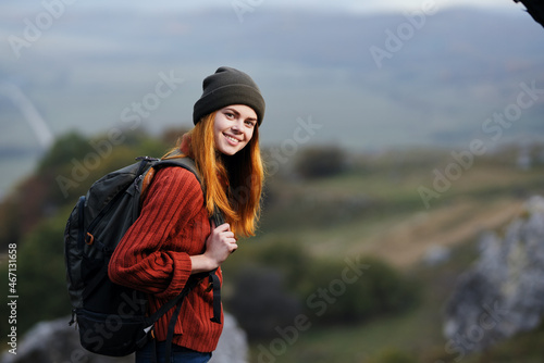 woman hiker with backpack in the mountains landscape fresh air adventure