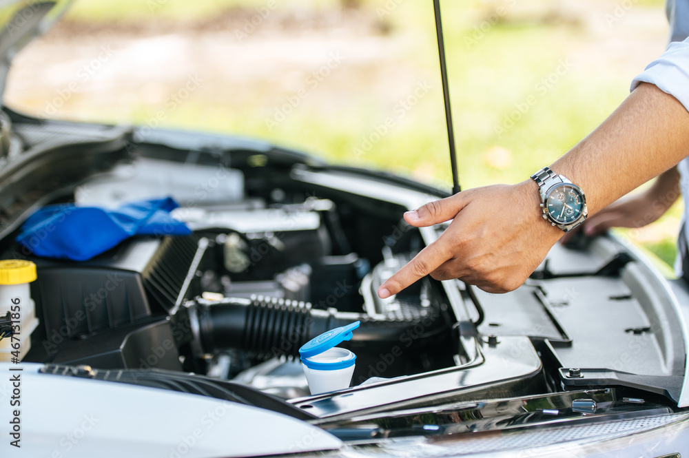 Man opens the hood of a car to fix the car. Man opens the hood of a car to fix the car.