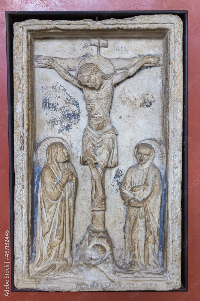 Stone bas-relief with a crucifix episode at the exhibition in the Castelvecchio Museum of the Castelvecchio Castello Scaligero fortress in Verona, Italy.