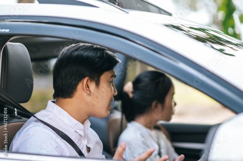 Women and men sit in cars and are stressed.