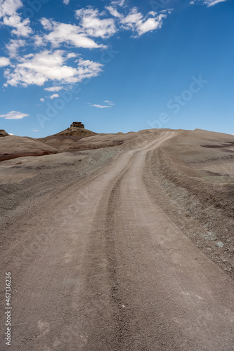 Dirt Road Climbs up Hill in Desert