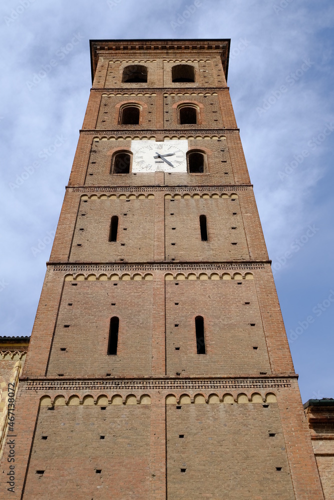 Bell tower. Romanesque bell tower in red brick.Ancient medieval bell tower with windows, arches and clock. 