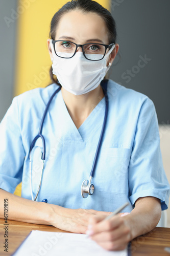 Beautiful health centre worker in cabinet