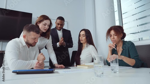 Wallpaper Mural Business people having meeting in office. Tracking shot multiethnic team of managers gathering around table and discussing company progress, looking at tablet. Concept of planning Torontodigital.ca