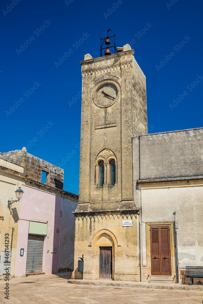 The small village of Acaya, Lecce, Salento, Puglia, Italy. The tower with the clock and the mullioned window. The small square paved in flat stone.