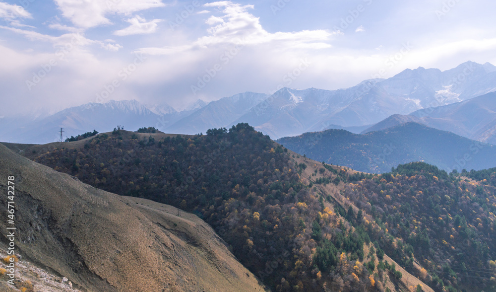 Rocks high in the mountains.. Mountain view on a clear autumn day. Mountains in Ingushetia. Landscape in the mountains in autumn. Rocks and trees in a mountainous area. Rocks high in the mountains.. Mountain view on a clear autumn day. Mountains in Ingushetia. Landscape in the mountains in autumn. Rocks and trees in a mountainous area.
