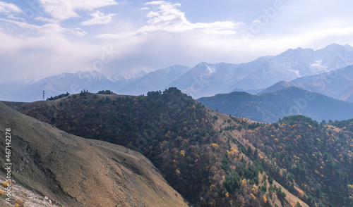 Rocks high in the mountains.. Mountain view on a clear autumn day. Mountains in Ingushetia. Landscape in the mountains in autumn. Rocks and trees in a mountainous area.