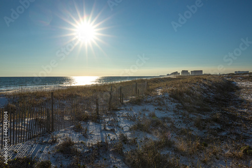 Sun burst over sandy beach coast