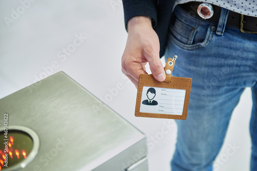 A man uses an electronic pass to pass through the turnstile. Ensuring the security of the company. Electronic document. photo