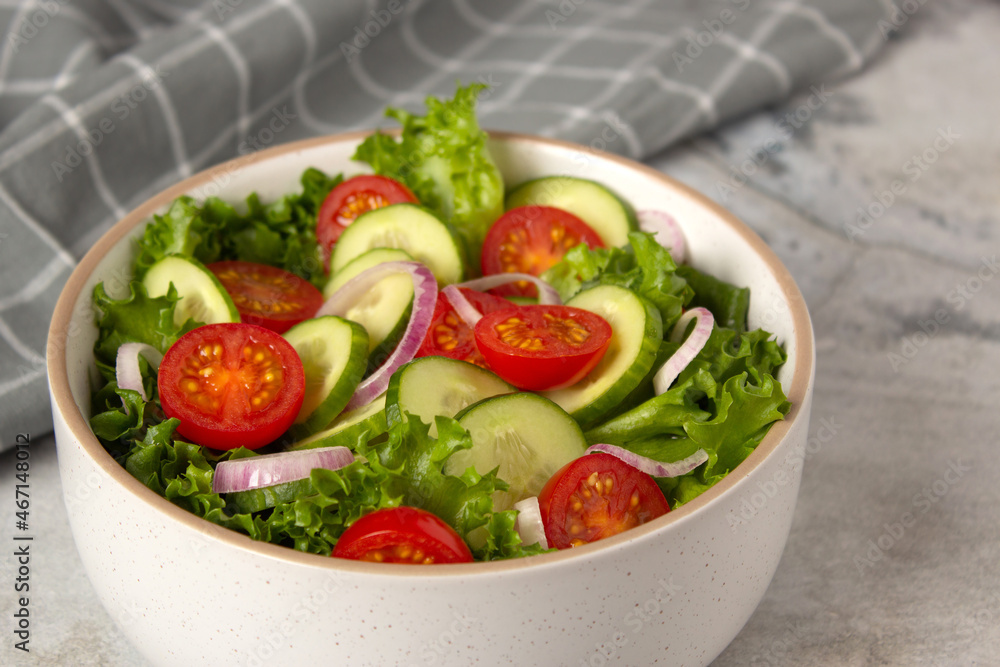 Vegetable green  salad with cucumber, tomato, onion and green salad. Close up photo of healthy food - obrazy, fototapety, plakaty 