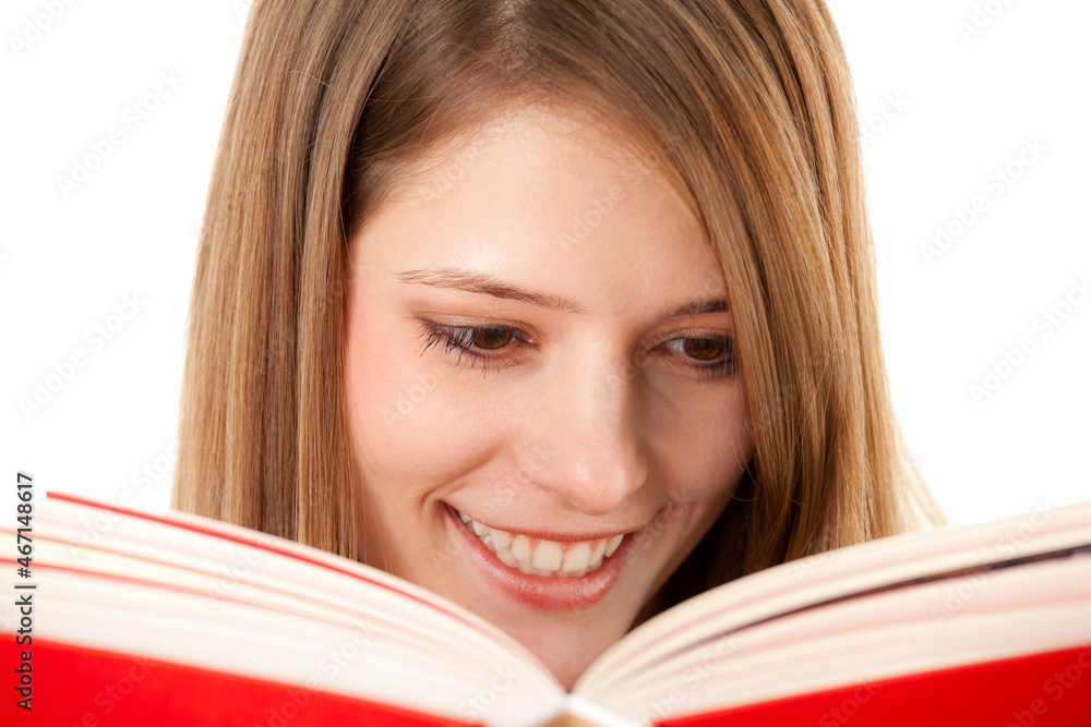Beautiful girl holding and reading her book, studio shot on white background Beautiful girl holding and reading her book, studio shot on white background