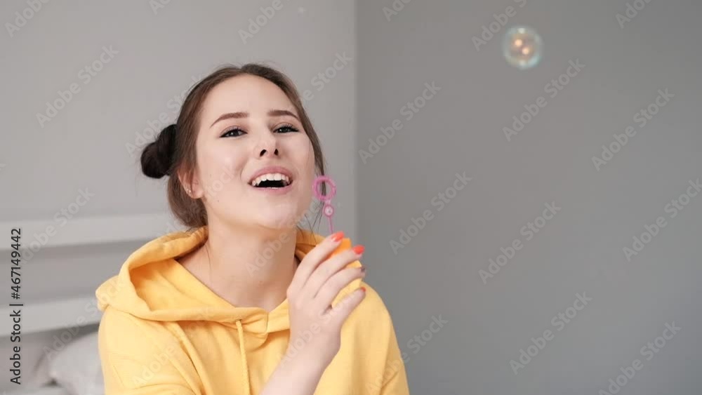 young woman girl in yellow making soap bubbles on grey background. happy, exited. slow motion. young woman girl in yellow making soap bubbles on grey background. happy, exited. slow motion.