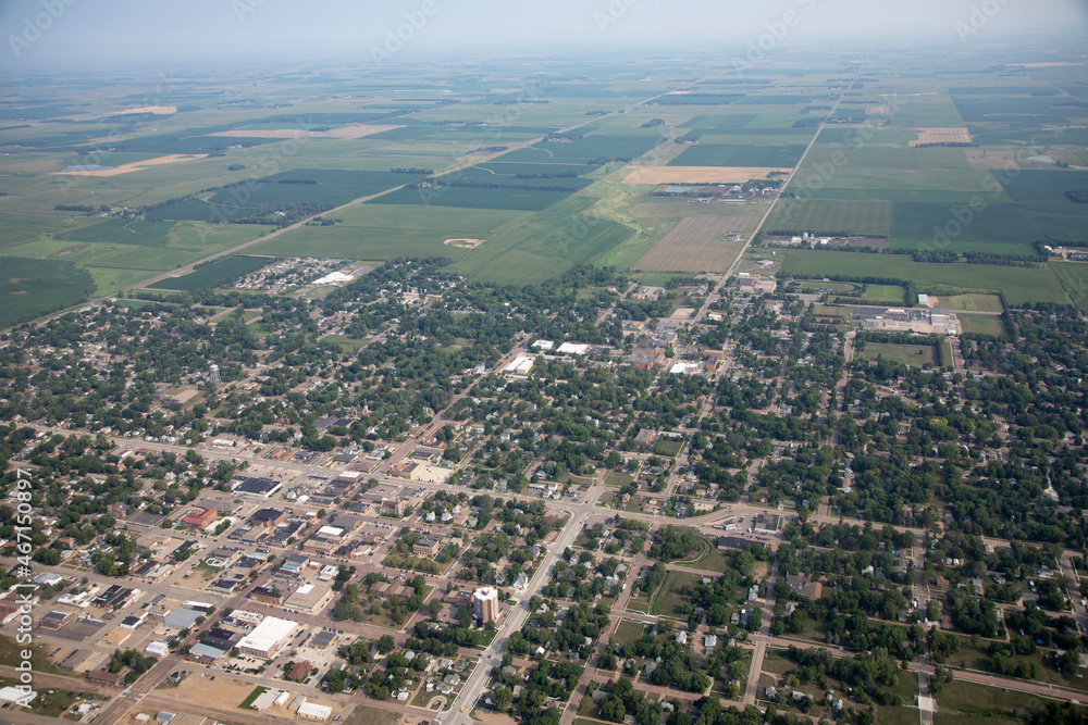 Fototapeta premium High aerial view of small farming town of Madison, South Dakota with farms in the background.