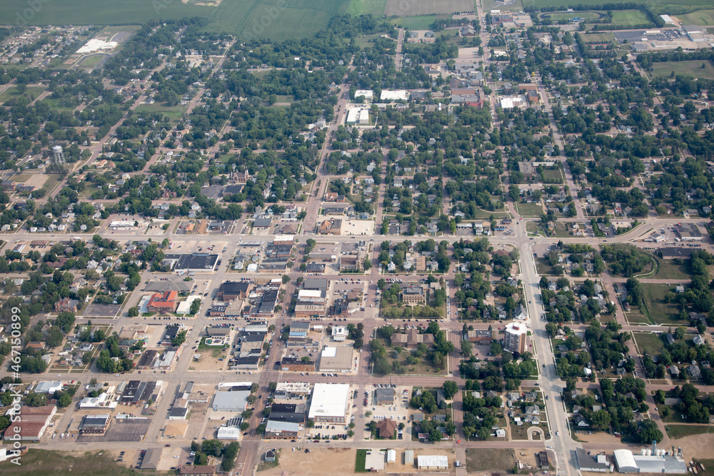 High aerial view of small farming town of Madison, South Dakota with farms in the background.