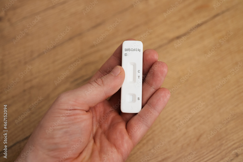 Man holding express COVID-19 antigen test. Man holding express COVID-19 antigen test.