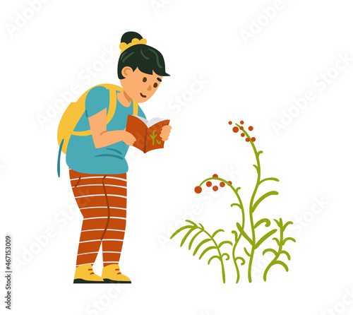 Girl, wearing striped leggings and a backpack, explore wild flowers outside. Girl checking info on her scout handbook