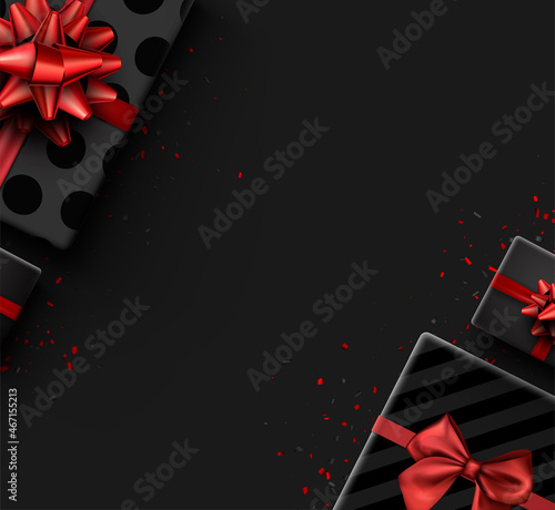 Black half hidden gift box with red bow.