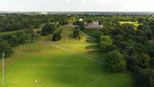 Green meadow, trees and buildings on hill in Greenwich park photo