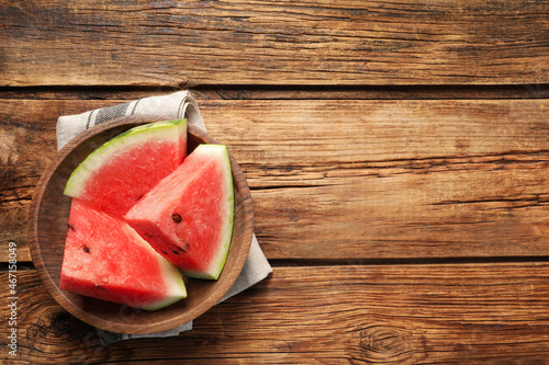 Delicious fresh watermelon slices on wooden table, top view. Space for text