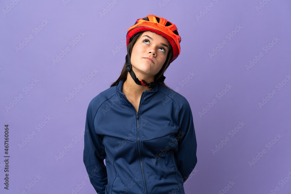 Teenager cyclist girl and looking up Teenager cyclist girl and looking up