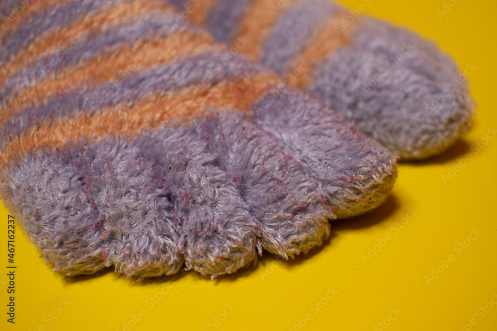 Fototapeta premium women's warm socks on a yellow background 