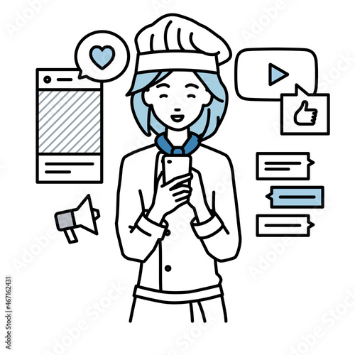 立ってスマートフォンでさまざまなSNSで楽しく交流する調理師の女性
