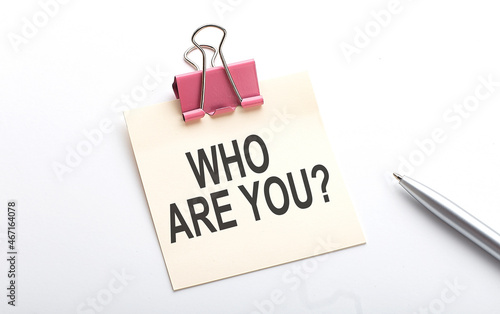 WHO ARE YOU text on sticker with pen on the white background