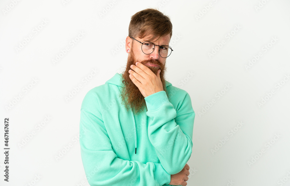 Young reddish caucasian man isolated on white background having doubts Young reddish caucasian man isolated on white background having doubts