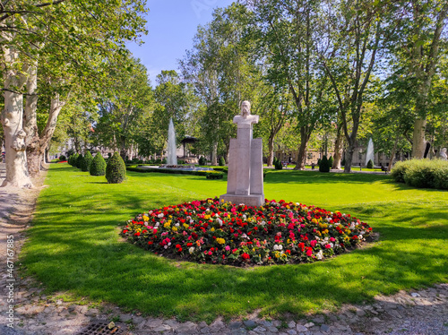 Bust of Ivan Mažuranić, Zagreb, Croatia, Zrinjevac Park in the background with green trees, fountain and flowers, popular touristic destination