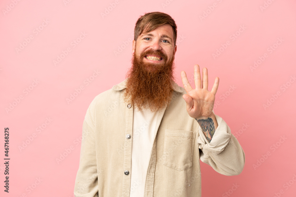 © luismolinero - Young reddish caucasian man isolated on pink background happy and counting four with fingers