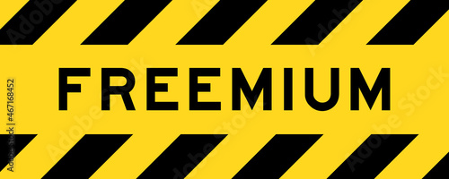 Yellow and black color with line striped label banner with word freemium