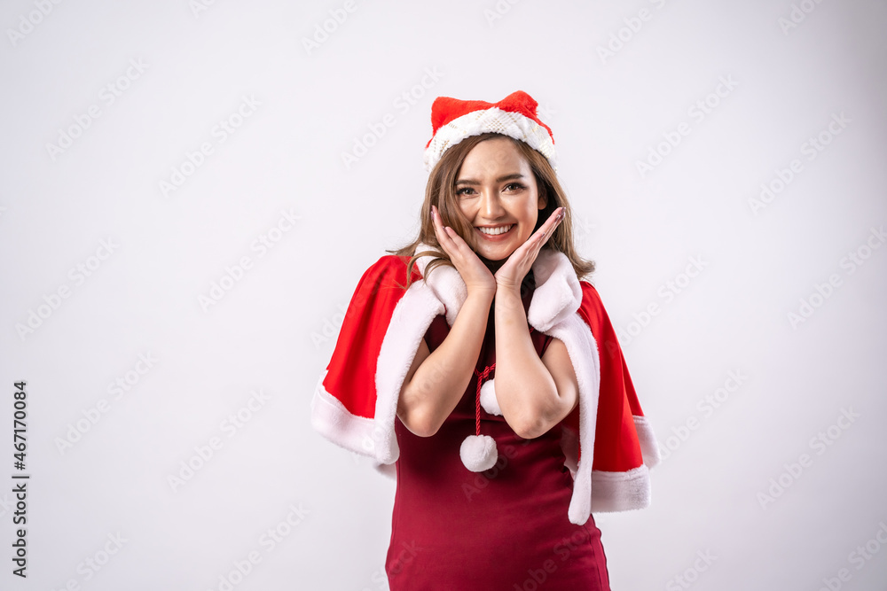 Beautiful Asian woman wearing santa costume and Santa hat,Happy New Year,Christmas,Celebration concept. Beautiful Asian woman wearing santa costume and Santa hat,Happy New Year,Christmas,Celebration concept.