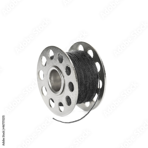 Metal spool of black sewing thread isolated on white