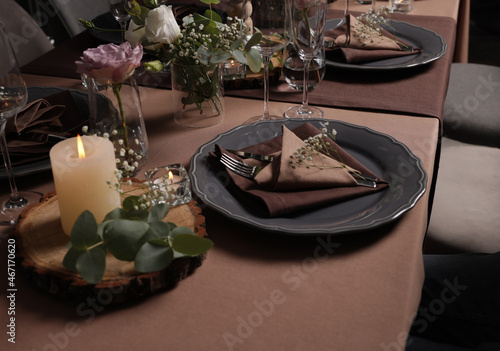 Elegant table setting with beautiful floral decor and burning candles