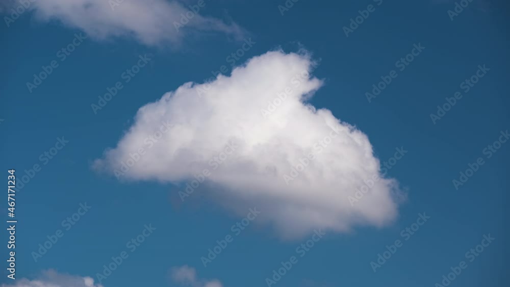 Bright landscape of white puffy cumulus clouds forming and changing under strong wind on blue sky Bright landscape of white puffy cumulus clouds forming and changing under strong wind on blue sky