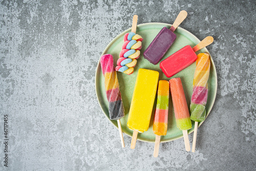colorful ice cream popsicles on dark backrgound photo