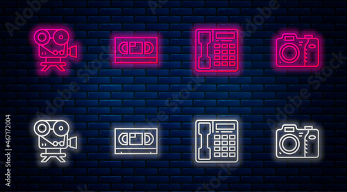 Set line VHS video cassette tape, Telephone handset, Retro cinema camera and Photo. Glowing neon icon on brick wall. Vector