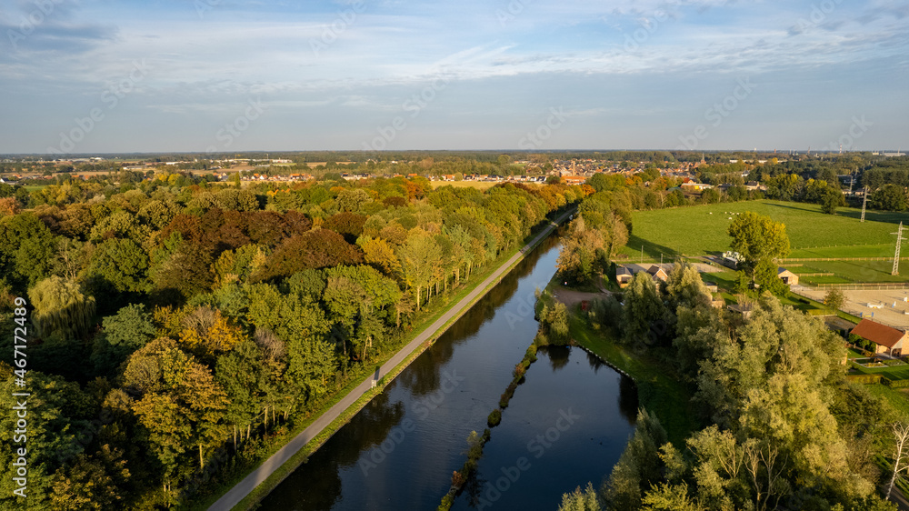 Aerial view the river on green forest plain. Amazing aerial shot of beautiful blue river. Forest background. High quality photo